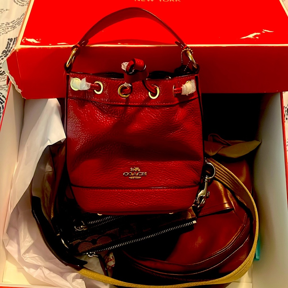 Small red coach bucket bag. Never used
